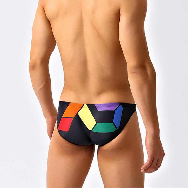 a sexy man in black Men’s Queer Grid Rainbow Pride Swim Briefs - pridevoyageshop.com - gay men’s sexy swim briefs, trunks, board shorts, and bikinis