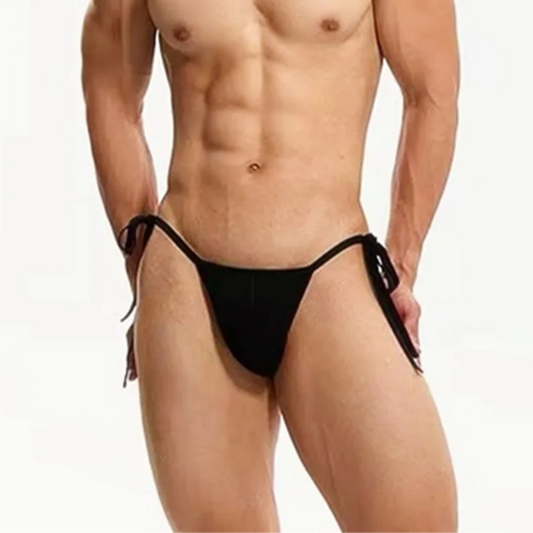 a sexy man in black Men’s Werk It Tie-Up Swim Bikini Thong – pridevoyageshop.com – gay men’s sexy swim briefs, trunks, board shorts, and bikinis