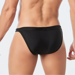 a sexy man in black Men’s Wet Package Micro Swim Briefs - pridevoyageshop.com - gay men’s sexy swim briefs, trunks, board shorts, and bikinis