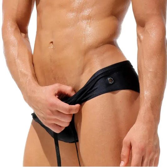 a sexy man in black Men’s Wettest Secret Swim BriefsMen’s Wettest Secret Swim Briefs - pridevoyageshop.com - gay men’s sexy swim briefs, trunks, board shorts, and bikinis
