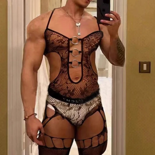 a sexy man in black lace bodystocking with O-ring chest detail, sheer floral lace and open-fit fetish silhouette – pridevoyageshop.com – gay men’s harness, lingerie and fetish wear