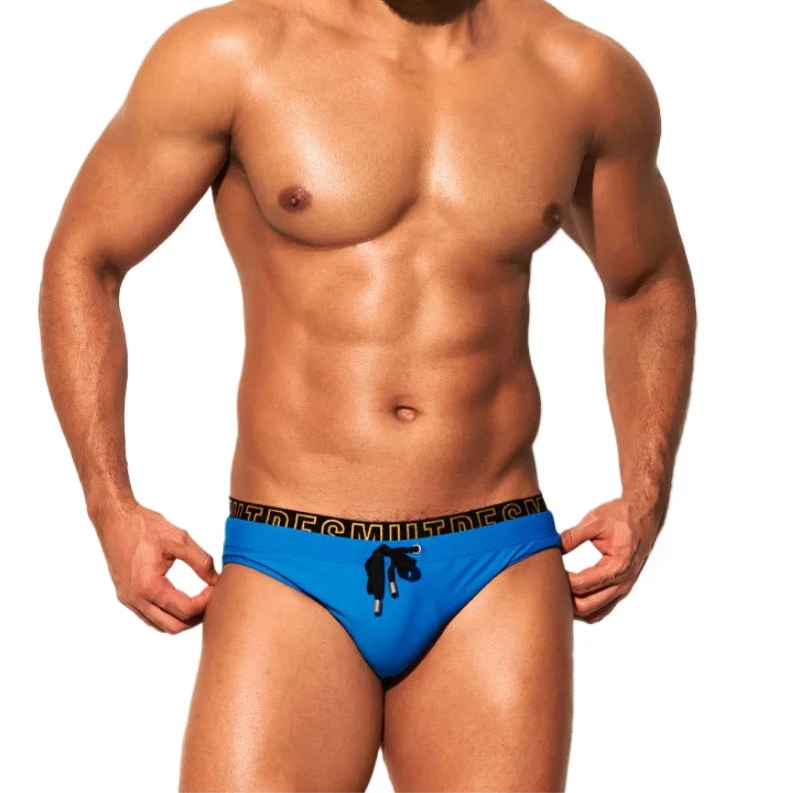 a sexy man in blue Desmiit Men's Wet Agenda Swim Briefs - pridevoyageshop.com - gay men’s sexy swim briefs, trunks, board shorts, and bikinis