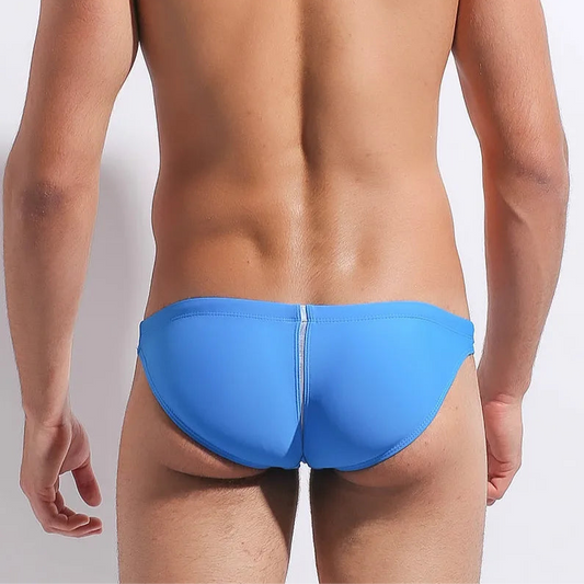 a sexy man in blue Men’s Fast & Curious Skinny Swim Briefs - pridevoyageshop.com - gay men’s sexy swim briefs, trunks, board shorts, and bikinis