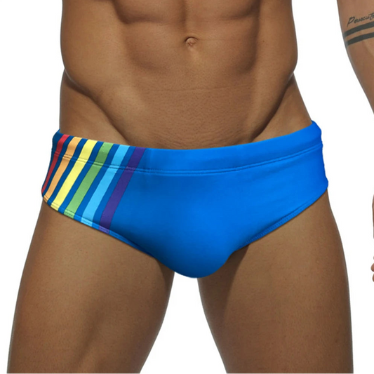 a sexy man in blue Men’s Pride Streak Bikini Swim Briefs - pridevoyageshop.com - gay men’s sexy swim briefs, trunks, board shorts, and bikinis