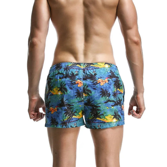 a sexy man in blue Men’s Tap-Ready Tides Swim Beach Surf Shorts – pridevoyageshop.com – gay men’s sexy swim briefs, trunks, board shorts, and bikinis