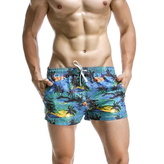 a sexy man in blue Men’s Tap-Ready Tides Swim Beach Surf Shorts – pridevoyageshop.com – gay men’s sexy swim briefs, trunks, board shorts, and bikinis