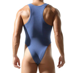 a sexy man in blue Submission Rib Thong Bodysuit – pridevoyageshop.com – gay men’s harness, lingerie and fetish wear