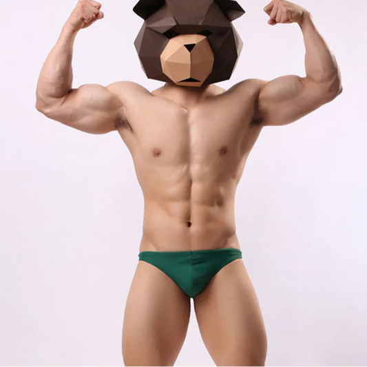 a sexy man in dark blue Men’s Fire Island Cabana Swim Bikini Thong – pridevoyageshop.com – gay men’s sexy swim briefs, trunks, board shorts, and bikinis