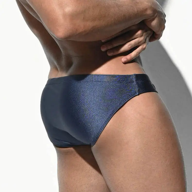 a sexy man in dark blue Men’s SleekFlex Bulge-Boost Swim Briefs - pridevoyageshop.com - gay men’s sexy swim briefs, trunks, board shorts, and bikinis
