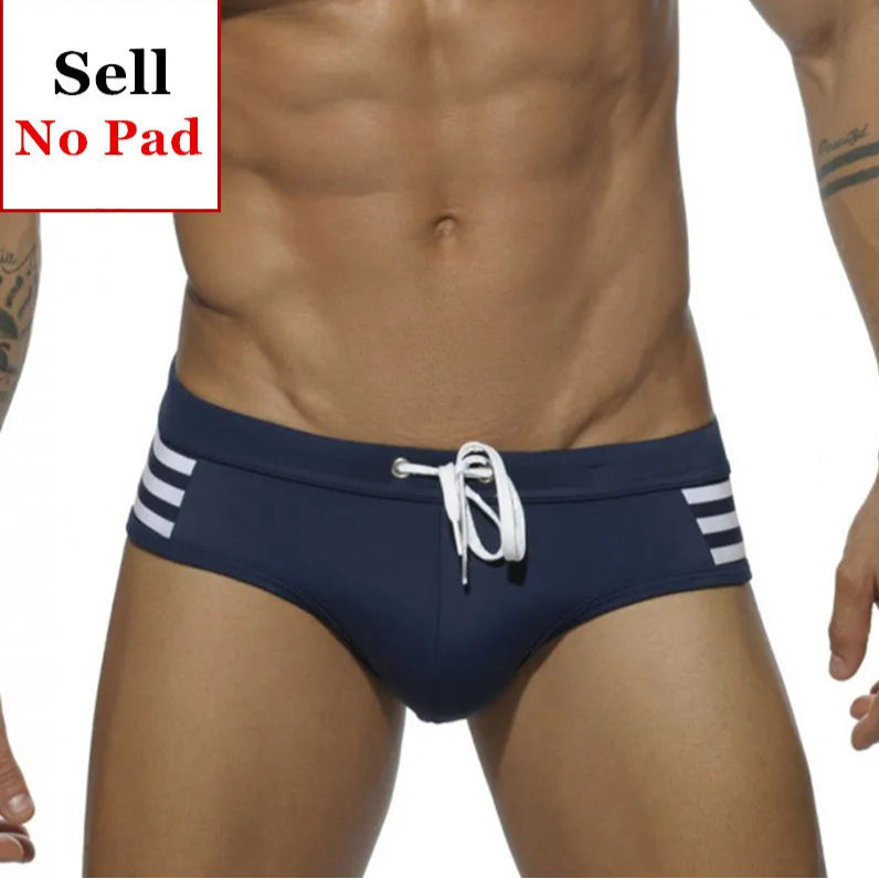 a sexy man in dark blue Men’s Striped Stallion Low Rise Swim Briefs - pridevoyageshop.com - gay men’s sexy swim briefs, trunks, board shorts, and bikinis