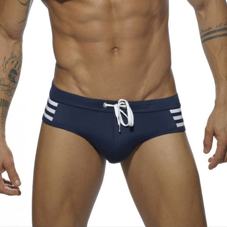a sexy man in dark blue Men’s Striped Stallion Low Rise Swim Briefs - pridevoyageshop.com - gay men’s sexy swim briefs, trunks, board shorts, and bikinis