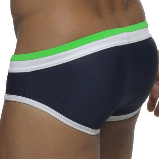 a sexy man in green and dark blue Men’s Split Decision Bulge Swim Briefs - pridevoyageshop.com - gay men’s sexy swim briefs, trunks, board shorts, and bikinis