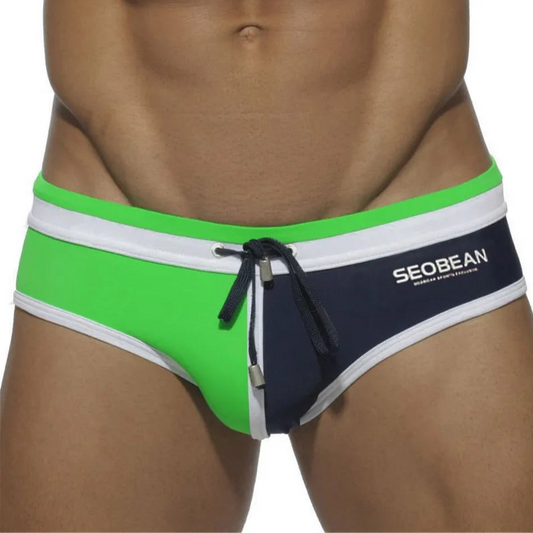 a sexy man in green and dark blue Men’s Split Decision Bulge Swim Briefs - pridevoyageshop.com - gay men’s sexy swim briefs, trunks, board shorts, and bikinis