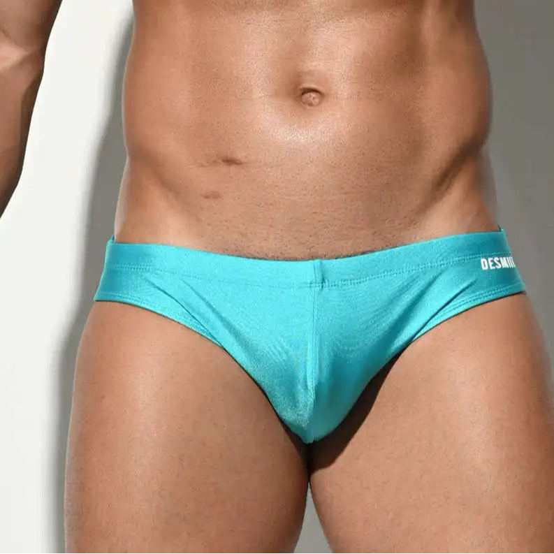 a sexy man in lake blue Men’s SleekFlex Bulge-Boost Swim Briefs - pridevoyageshop.com - gay men’s sexy swim briefs, trunks, board shorts, and bikinis