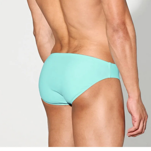 a sexy man in light blue Desmiit Men’s Brunch-Ready Bikini Swim Briefs - pridevoyageshop.com - gay men’s sexy swim briefs, trunks, board shorts, and bikinis