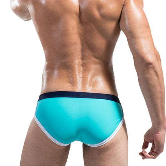 a sexy man in light blue Desmiit Men’s Colorblock Speed Bulge Swim Briefs - pridevoyageshop.com - gay men’s sexy swim briefs, trunks, board shorts, and bikinis