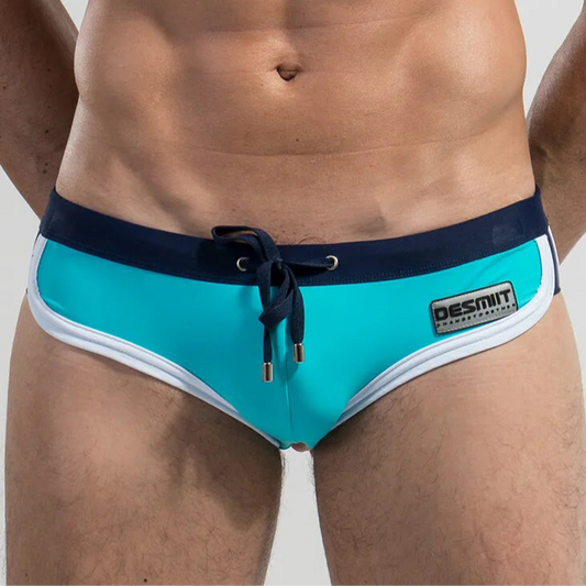 a sexy man in light blue Desmiit Men’s Colorblock Speed Bulge Swim Briefs - pridevoyageshop.com - gay men’s sexy swim briefs, trunks, board shorts, and bikinis