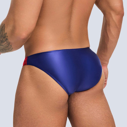 a sexy man in navy blue Men’s Ultra-Slick Wet Werk Mini Swim Briefs - pridevoyageshop.com - gay men’s sexy swim briefs, trunks, board shorts, and bikinis