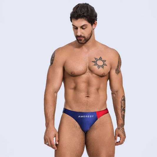 a sexy man in navy blue Men’s Ultra-Slick Wet Werk Mini Swim Briefs - pridevoyageshop.com - gay men’s sexy swim briefs, trunks, board shorts, and bikinis