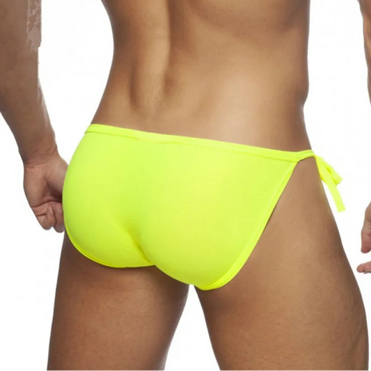 a sexy man in neon yellow Men’s Barely Hooked Side Tie Bikini Swim Briefs - pridevoyageshop.com - gay men’s sexy swim briefs, trunks, board shorts, and bikinis