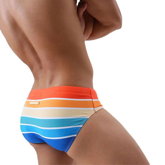 a sexy man in orange Men’s Bottom Line Stripe Swim Briefs - pridevoyageshop.com - gay men’s sexy swim briefs, trunks, board shorts, and bikinis