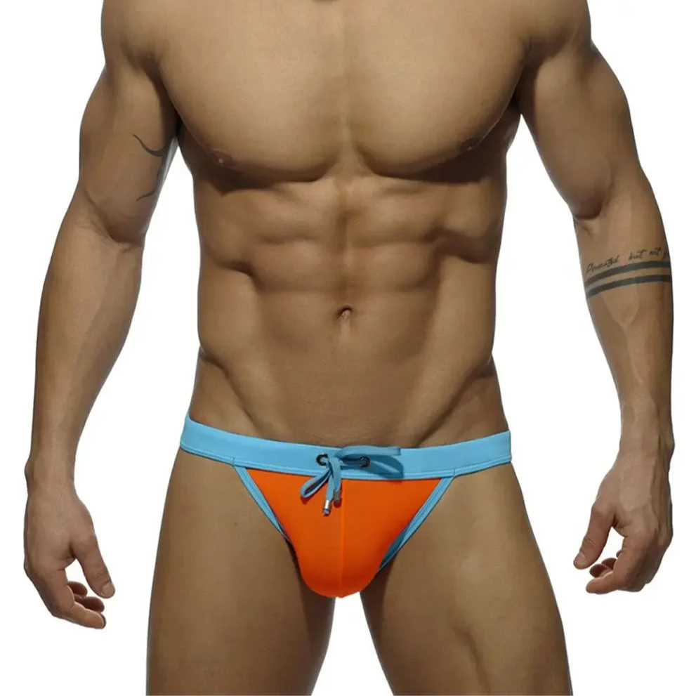 a sexy man in orange Men’s Forbidden Fruit Bikini Swim Briefs - pridevoyageshop.com - gay men’s sexy swim briefs, trunks, board shorts, and bikinis