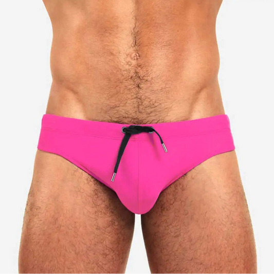 a sexy man in pink Men’s Beach Brat Swim Briefs - pridevoyageshop.com - gay men’s sexy swim briefs, trunks, board shorts, and bikinis
