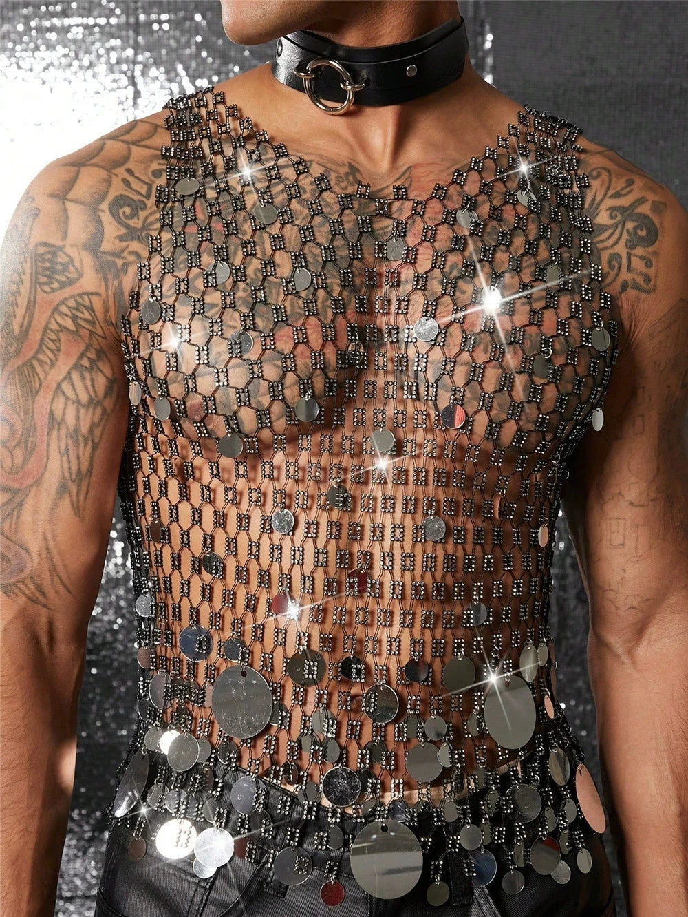a sexy man in silver coinmail tank with metal discs draping over chest, showing sculpted torso and chain-style shimmer – pridevoyageshop.com – gay men’s harness, lingerie and fetish wear