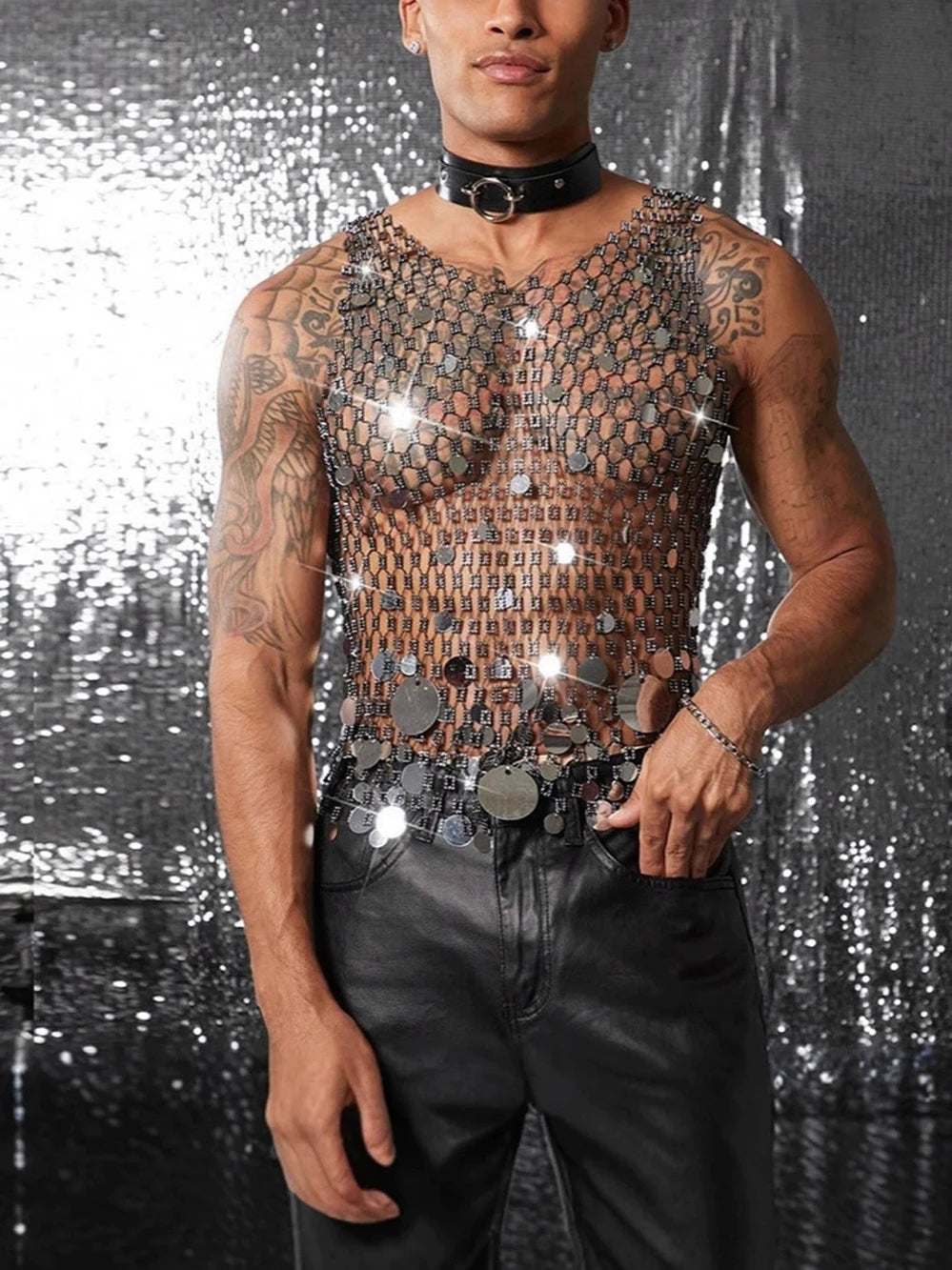 a sexy man in silver coinmail tank with metal discs draping over chest, showing sculpted torso and chain-style shimmer – pridevoyageshop.com – gay men’s harness, lingerie and fetish wear