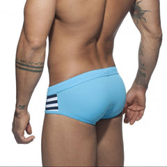 a sexy man in sky blue Men’s Striped Stallion Low Rise Swim Briefs - pridevoyageshop.com - gay men’s sexy swim briefs, trunks, board shorts, and bikinis