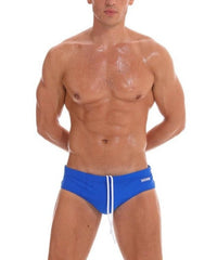 a sexy gay man in Men's Solid Blue Swim Briefs - pridevoyageshop.com - gay men’s underwear and swimwear