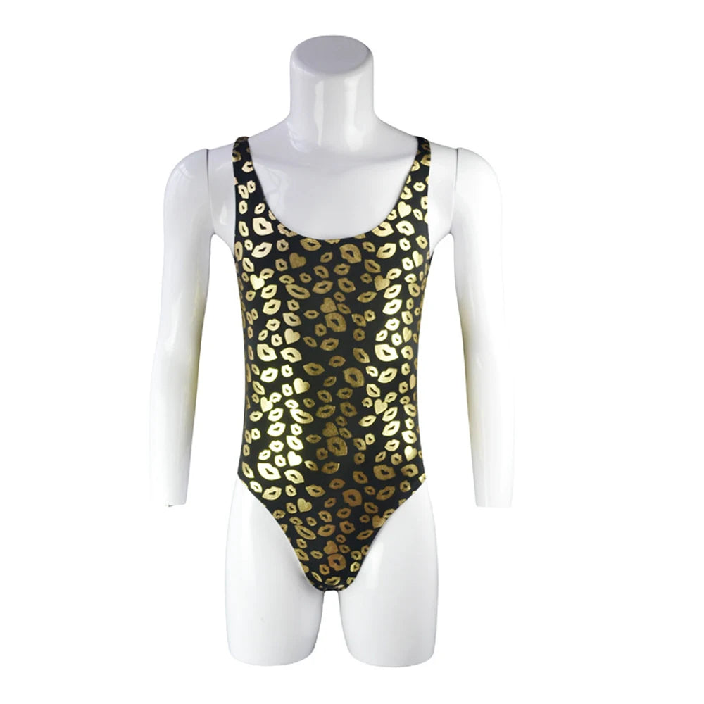 flat lay of black kiss-print racerback leotard with bold lip pattern and high-cut silhouette – pridevoyageshop.com – gay men’s harness, lingerie and fetish wear