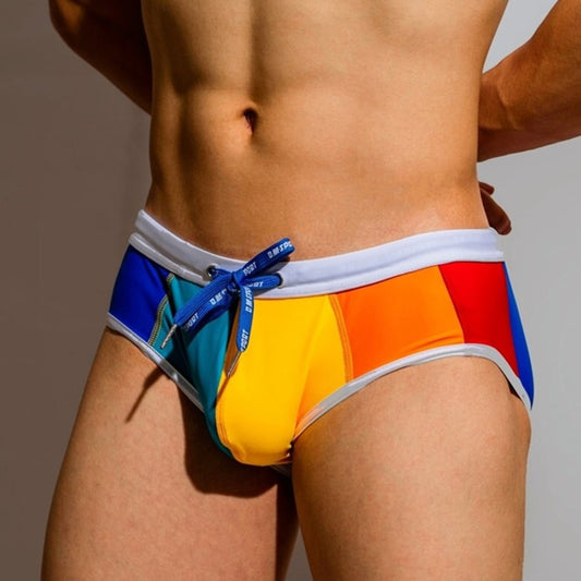 sexy gay man in Gay Swimwear | DM Rainbow Swim Briefs- pridevoyageshop.com - gay men’s underwear and swimwear