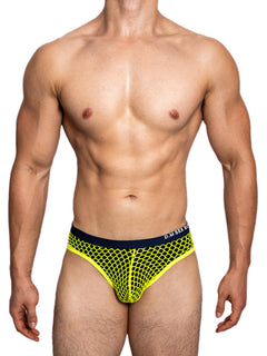 a sexy gay man in neon yellow DM Sexy Boy Fishnet Briefs - pridevoyageshop.com - gay men’s underwear and swimwear