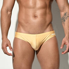 A sexy man in light yellow Desmiit Men’s Bulge Master Low Rise Swim Briefs - pridevoyageshop.com - gay men’s sexy swim briefs, trunks, board shorts, and bikinis