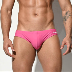 A sexy man in pink Desmiit Men’s Bulge Master Low Rise Swim Briefs - pridevoyageshop.com - gay men’s sexy swim briefs, trunks, board shorts, and bikinis