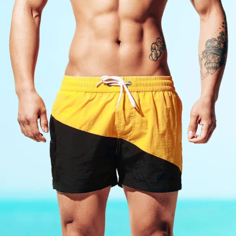 a hot guy in yellow Tidal Charm Two Toned Board Shorts - pridevoyageshop.com - gay men’s underwear and swimwear