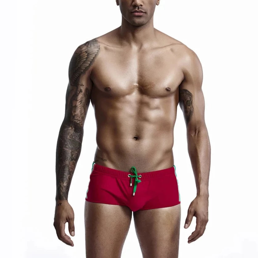 a hot gay man in red Bold Stripe Swim Trunks - pridevoyageshop.com - gay men’s underwear and swimwear