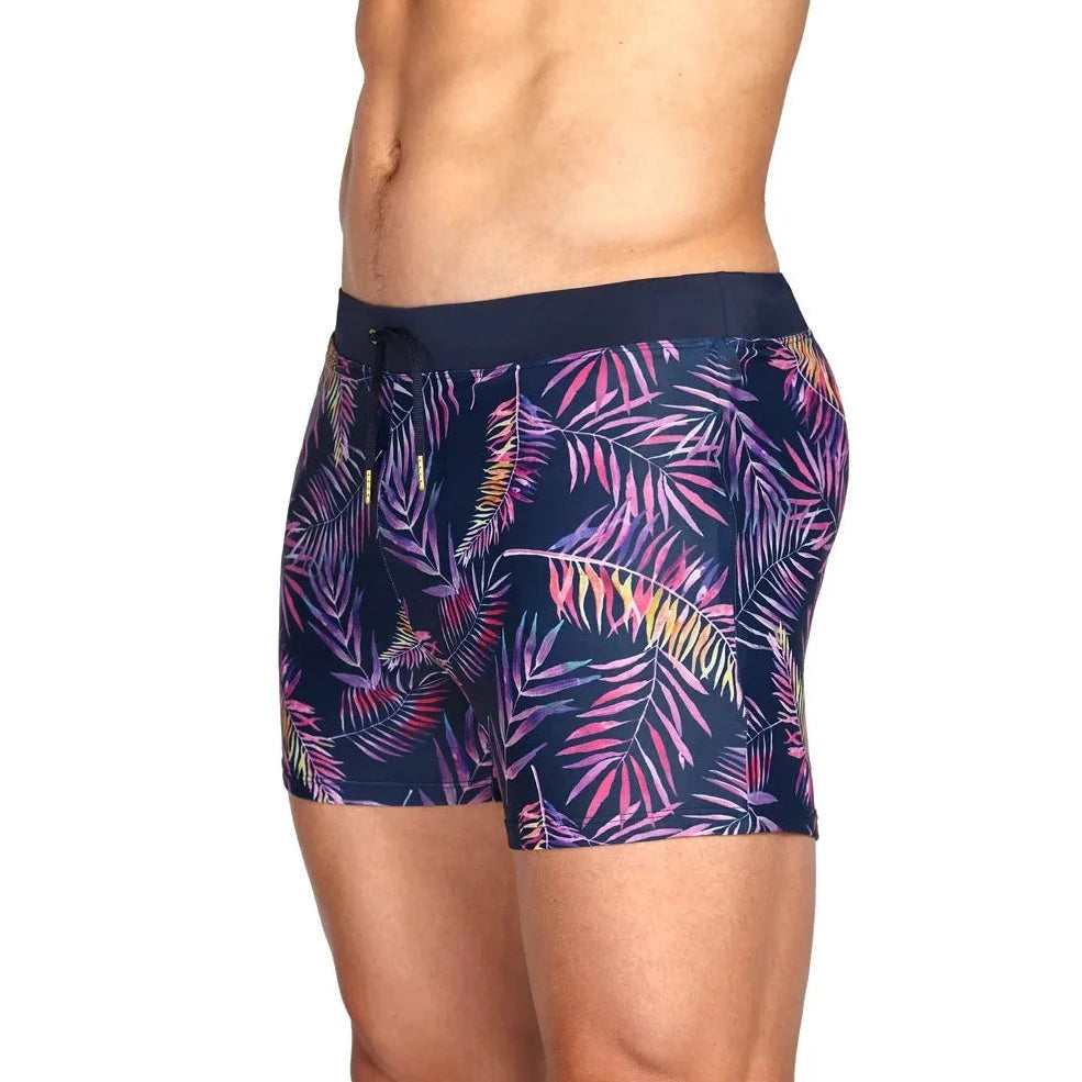 a hot gay man in Neon Palms Swim Trunks - pridevoyageshop.com - gay men’s underwear and swimwear