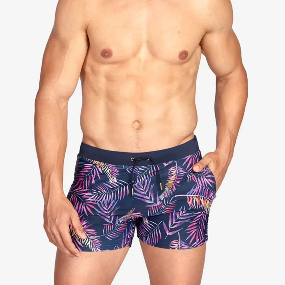 a hot gay man in Neon Palms Swim Trunks - pridevoyageshop.com - gay men’s underwear and swimwear