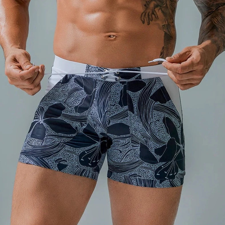 a hot gay man in light blue Wild Island Flirt Swim Trunks - pridevoyageshop.com - gay men’s underwear and swimwear