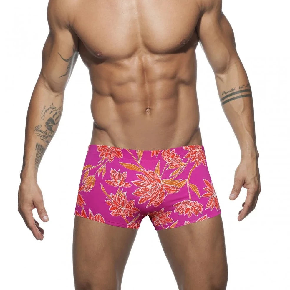 a hot gay man in pink Bold Neon Forest Swim Trunks - pridevoyageshop.com - gay men’s underwear and swimwear