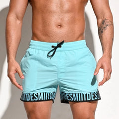 a hot man in sky blue Desmiit Scripted Tide Board Shorts - pridevoyageshop.com - gay men’s underwear and swimwear