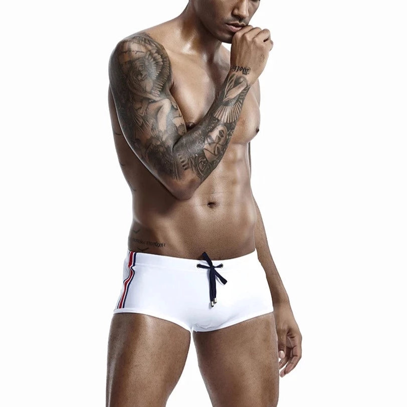 a hot gay man in white Bold Stripe Swim Trunks - pridevoyageshop.com - gay men’s underwear and swimwear