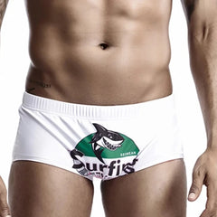 a hot gay man in green Shark Surfing Swim Trunks - pridevoyageshop.com - gay men’s underwear and swimwear