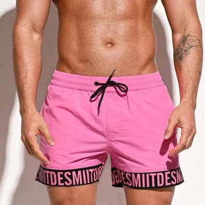 a hot man in pink Desmiit Scripted Tide Board Shorts - pridevoyageshop.com - gay men’s underwear and swimwear