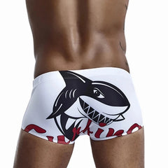 a hot gay man in white Shark Surfing Swim Trunks - pridevoyageshop.com - gay men’s underwear and swimwear
