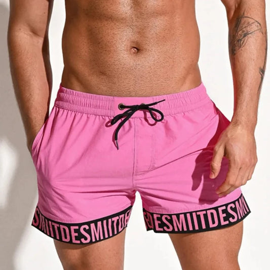 a hot man in pink Desmiit Scripted Tide Board Shorts - pridevoyageshop.com - gay men’s underwear and swimwear