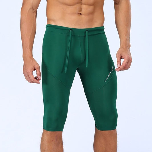 sexy gay man in dark green Gay Leggings | Men's Sexy 3/4 Compression Sport Leggings - pridevoyageshop.com - gay men’s underwear and activewear