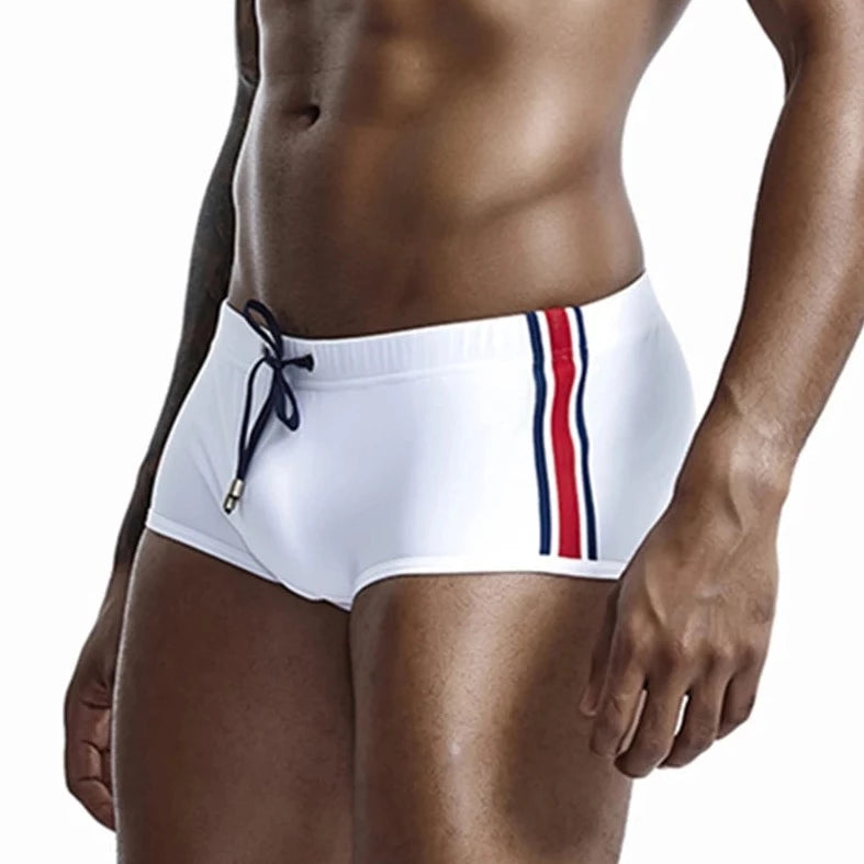 a hot gay man in white Bold Stripe Swim Trunks - pridevoyageshop.com - gay men’s underwear and swimwear